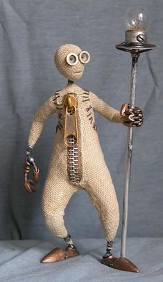 a small toy figure holding a metal pole