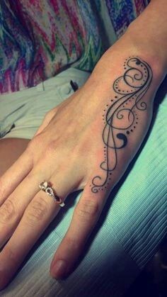 a woman's hand with a tattoo on it