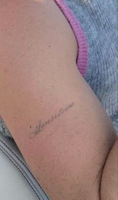 a woman's stomach with the word love written in cursive writing on it