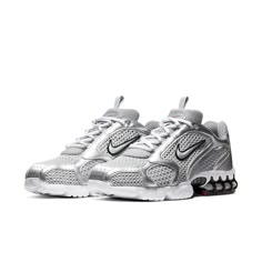 The Nike Air Zoom Spiridon Cage 2 Metallic Silver combines retro flair with futuristic design. Crafted for men, this sneaker features a mesh and synthetic leather upper coated in a sleek metallic silver finish. The raised Swoosh branding on the quarter panel adds a bold touch. Underfoot, a white foam midsole houses a caged Zoom Air unit in the heel for cushioning. The rubber outsole introduces hits of red for a pop of color. Whether you’re hitting the streets or making a style statement, these k Nike Air Zoom Spiridon, Early 2000s Style, Trendy Shoes Sneakers, Pretty Shoes Sneakers, Baskets Nike, Cute Sneakers, Nike Dunk High, Swag Shoes, Nike Blazer