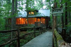 a small cabin in the woods with a wooden walkway leading to it and a sign that says napa