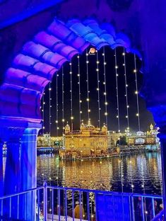 the golden temple lit up at night with lights on it's walls and water below