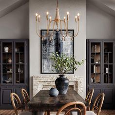 a dining room table with chairs and a large painting on the wall above it's head