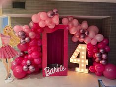 the balloon arch is decorated with pink, silver and white balloons that spell out barbie's number four