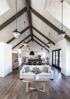 a living room filled with furniture and lots of wood flooring on top of a hard wood floor