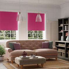 a living room with two pink shades on the windows