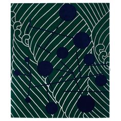 a green rug with blue and white designs on the front, along with an abstract design