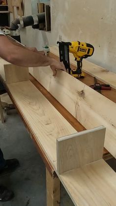 a man sanding wood with a power drill