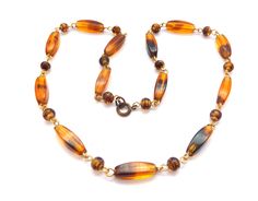 A vintage caramel and toffee tone givre glass beaded short length necklace. Formed from elongated faceted givre glass beads and rounded spiral patterned beads,  short length with a spring ring fastener.  Circa 1960's - 70's.       Givre glass beads     Length of necklace approx 45cm, so  short princess in length.     Unsigned.     Spring ring fastener.     Good vintage condition.     Circa 1960's - 70's. All items are carefully selected to appear in the shop. We stock items across a range of era Length Necklace, Spiral Pattern, Toffee, Spring Rings, Favorite Jewelry, The Collector, Caramel, Glass Beads, Beaded Necklace