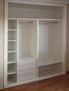 an empty white closet with shelves and drawers