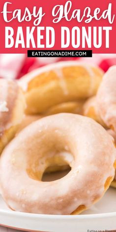 several glazed donuts on a white plate with red and white checkered tablecloth