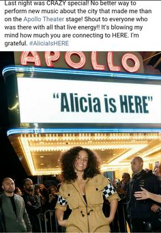 a woman standing in front of a marquee with the words'albia is here '