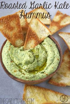 roasted garlic kale hummus in a bowl with crackers