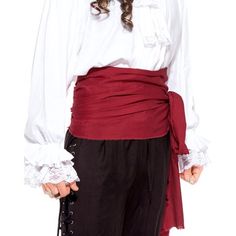 a woman in pirate garb is posing for the camera with her hands on her hips