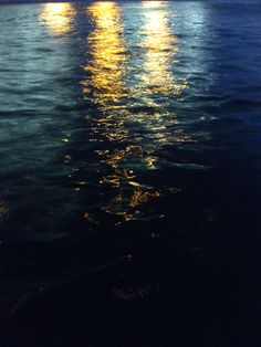 the full moon shines brightly over the water