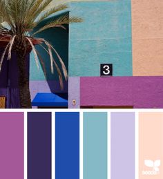 a palm tree in front of a multi - colored building with the number 3 on it