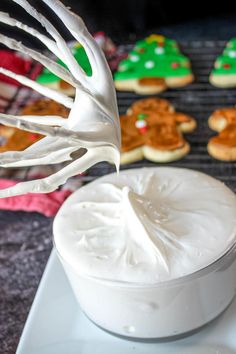 the icing is being drizzled onto cookies