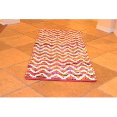 a multicolored area rug on the floor