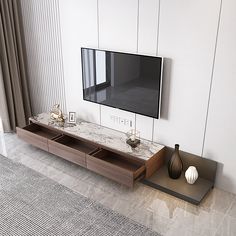 a flat screen tv mounted to the side of a wall next to a vase on a tray