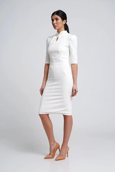 "Elegant midi dress featuring a fitted sheath silhouette, midi length and a high neck collar. - modern cheongsam style - keyhole mandarin neck with fabric button - fitted pencil silhouette - knee length (midi) - 2/3 puffy sleeves  - french darts - сoncealed back zipper closure - lined bodice Color: milky white Fiber: viscose - 40%, elastane - 5%, polyester - 55% Lining: viscose - 95 %, elastane - 5% For Size 2 US / 36 EU: dress length - 40\"(102 cm), sleeve length - 14,5\" (37 cm) Our model wear Elegant Fitted High Neck Bodycon Dress, Elegant High-neck Bodycon Dress For Formal Occasions, Elegant High Neck Bodycon Dress For Formal Occasions, Elegant High Neck Bodycon Dress For Formal Events, Elegant High Neck Bodycon Dress For Formal, Elegant White Cheongsam For Spring, White Fitted Cheongsam With Stand Collar, Elegant High Neck Bodycon Dress, Elegant Spring Dress With Band Neckline