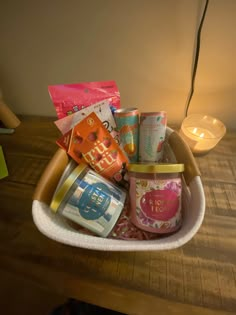 a basket filled with lots of different types of items on top of a wooden table