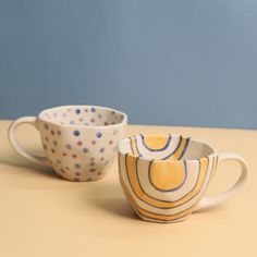 two cups sitting next to each other on a table