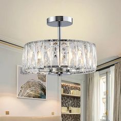 a chandelier hanging from the ceiling in a living room