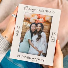 two women holding up a photo frame with the words, once my bridesmaid