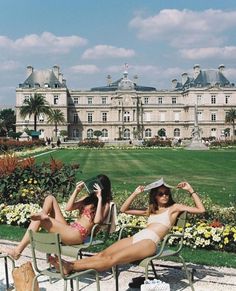 two women in bikinis lounging on lawn chairs