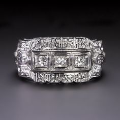 an art deco diamond ring on a black background