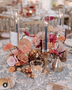 a table topped with lots of flowers and candles