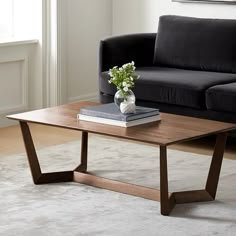 a living room with a black couch and coffee table