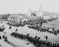 an old black and white photo of people riding horses