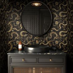 a bathroom vanity with an oval mirror and black wallpapered walls, along with a round sink