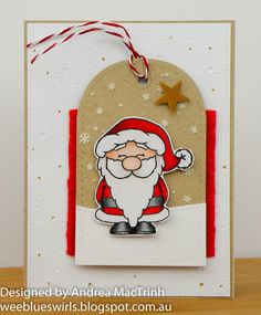 a handmade christmas card with a santa clause holding a star on the front and an ornament hanging from it's side