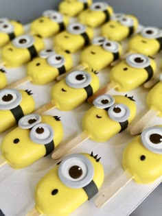 some yellow and black minion pops with eyes on them are lined up in rows