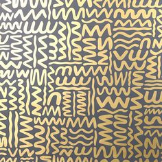 an abstract gold and black wallpaper with white letters on it's side,