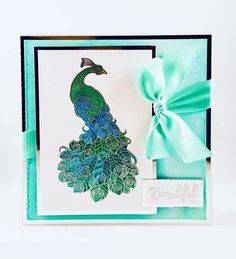 a card with a peacock on it and a bow