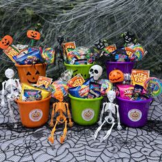 halloween candy in buckets with skeletons and jack - o'- lanterns