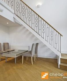 a living room filled with furniture and a stair case next to a glass top table