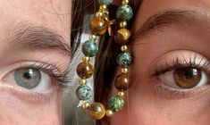 two women's eyes are shown with beads on their forehead and in between them