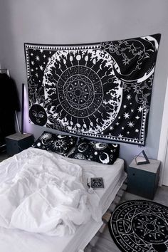 a black and white tapestry hanging over a bed