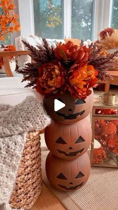 a pumpkin vase with flowers in it sitting on a table