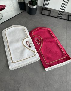 two towels laying on the floor next to each other, one with scissors in it