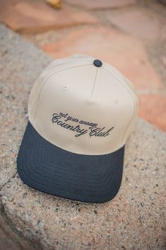 Make a statement with our Black/Khaki hat, featuring bold black embroidered text that reads 'Not Your Average Country Club.' This cap blends urban style with a touch of attitude. -Made from a durable blend of 65% polyester and 35% cotton -Snap back design Embroidered Text, Sky Collection, School Collection, Embroidered Hat, Embroidered Hats, Top Graphic Tees, Cardigan Vest, Black Khakis, Urban Style