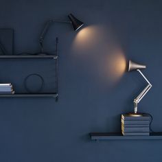 a desk lamp sitting on top of a book shelf