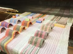 there are many pieces of weaving on the table