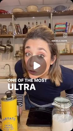 a woman making a funny face in front of a stove top with the words one of the most ultra on it