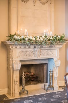 the fireplace is decorated with flowers and candles