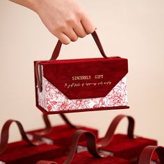 a person is holding a red and white box with the words sunday gift on it